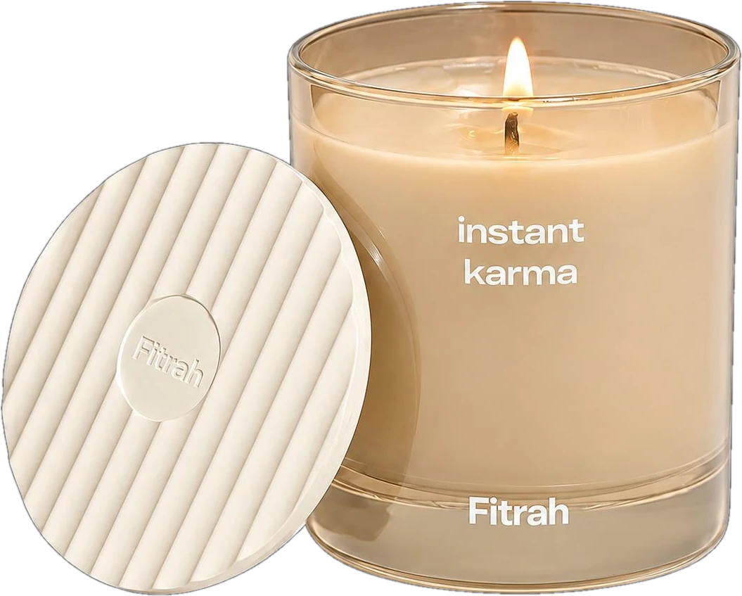 Fitrah Instant Karma candle in ivory glass, lit, beside its ribbed ceramic lid